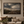 After the Storm framed wall art in a dark wood frame above a living room sofa