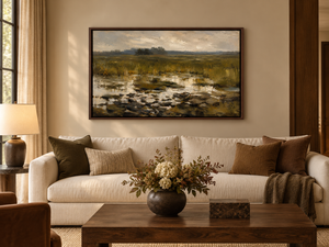 Lowland framed wall art hanging above a sofa in a living room