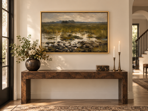Lowland framed wall art in an entryway above a console table