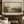 Olive Ground framed wall art in a dark wood frame above a living room sofa