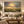 Prairie After the Storm framed wall art in an antiqued gold frame in a neutral living room