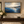 The Far Shore framed wall art in an entryway above a console table