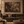 The Forgotten Garden framed wall art in a dark wood frame above a living room sofa