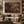 The Forgotten Garden framed wall art in a black frame in a modern living room