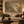 The Golden Leaves framed wall art in an antiqued gold frame in a neutral living room