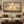 The Great Light framed wall art in a dark wood frame above a living room sofa