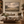 The Shepherd and His Flock framed wall art in a dark wood frame above a living room sofa