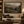 Through the Valley framed wall art in a dark wood frame above a living room sofa