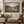 Wool Pastures framed wall art in a dark wood frame above a living room sofa